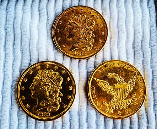 Three gold coins recovered by the divers at Blue Water Ventures