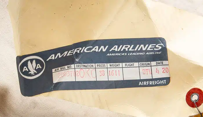 Close-up photo of a 1967 American Airlines shipping tag on a canvas bag containing 2,000 silver half-dollars struck in 1963 at the Denver Mint. Now owned by an elderly Oklahoma woman who received it a half-century ago from her father, this original bag of historic coins is expected to sell for $100,000 or more in an auction conducted by Rare Collectibles TV on July 27, 2023. Photo credit: Rare Collectibles TV.