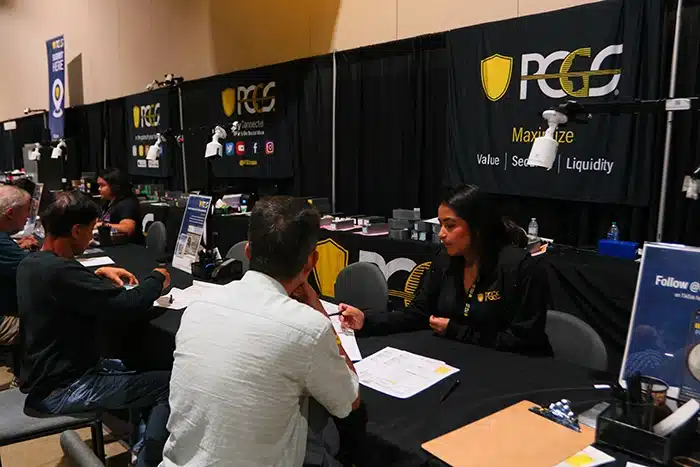 Collectors submit coins for certification at the PCGS booth. Image: PCGS.