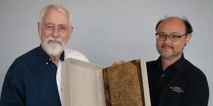 First Printed Numismatic Book Donated to American Numismatic Association: Dr. Bruce D. Wonder, left, presenting Budé's De Asse et Partibus Eius Libri Quing to ANA Library Manager Akio Lis. Image: American Numismatic Association.