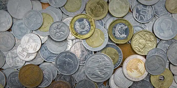 A pile of modern world coins. Image: Adobe Stock.