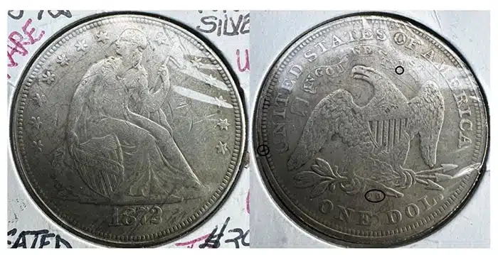Counterfeit 1872 Liberty Seated One Dollar coin in a 2x2 holder. Image: Jack Young.