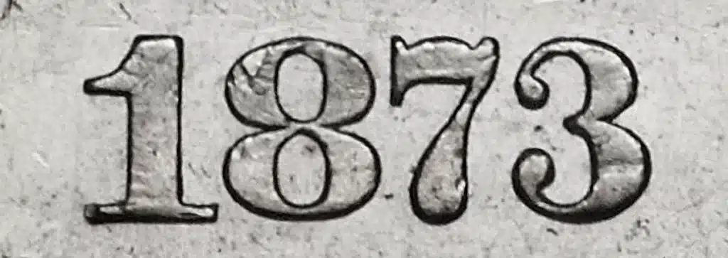 1873 “open 3” date on a no arrows half dollar.