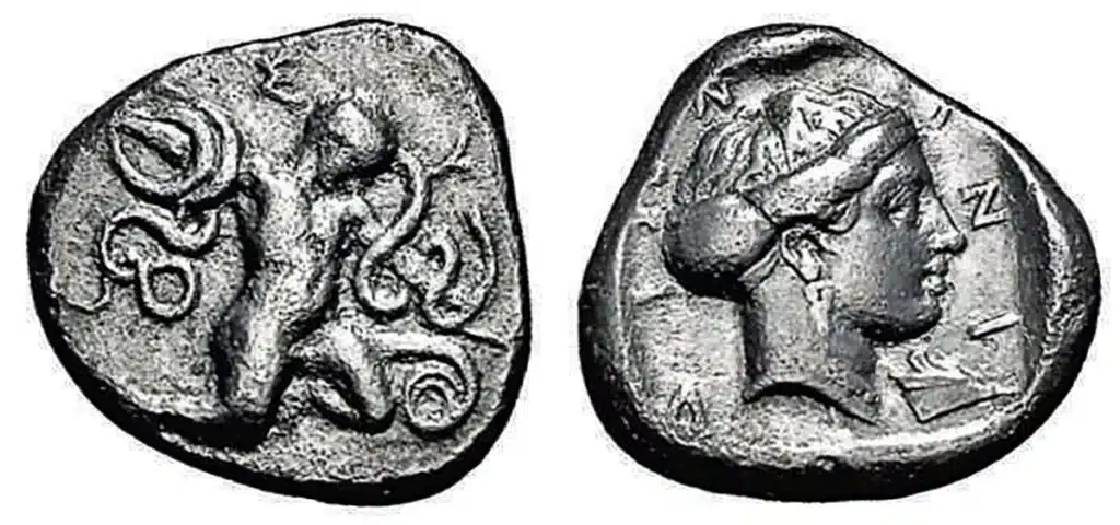 Figure 8: Knidos, Caria. 405-394 BCE. AR Tridrachm O: SUN; the childlike Heracles strangles snakes. R: KNIDIWN, Aphrodite's head with earrings and necklace right, the hair in sphendone, prow below chin. Everything in square incuse, 10.7 g., Keckmann 164. (Roma Numismatics 13, Lot: 334, $9800, 3/23/17).