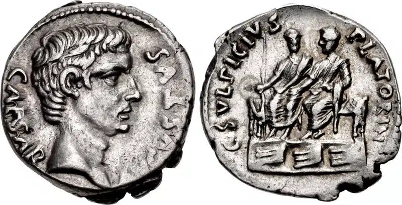Figure 6: Augustus. 27 BCE - 14 CE. AR Denarius. Rome mint, C. Sulpicius Platorinus, moneyer. Struck 13 BCE. AVGVSTVS CAESAR, bare head right / C • SVLFIVI PLATO- RIN, Augustus and Agrippa, bare headed and togated, seated side by side, facing slight left, on a bisellium, placed on a platform which is ornamented with three rostra: on left. staff or spear, 19mm, 3.78g., RIC 407. (CNG 109, Lot: 597, $7500, 3/2/05).