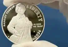 A mint employee holds up the first Harriet Tubman commemorative dollar. Image: U.S. Minr.