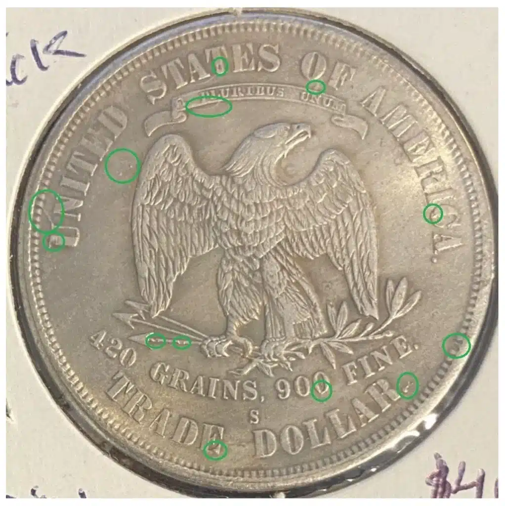Intersting attribution marks on the reverse of a counterfeit 1874-S Trade Dollar.