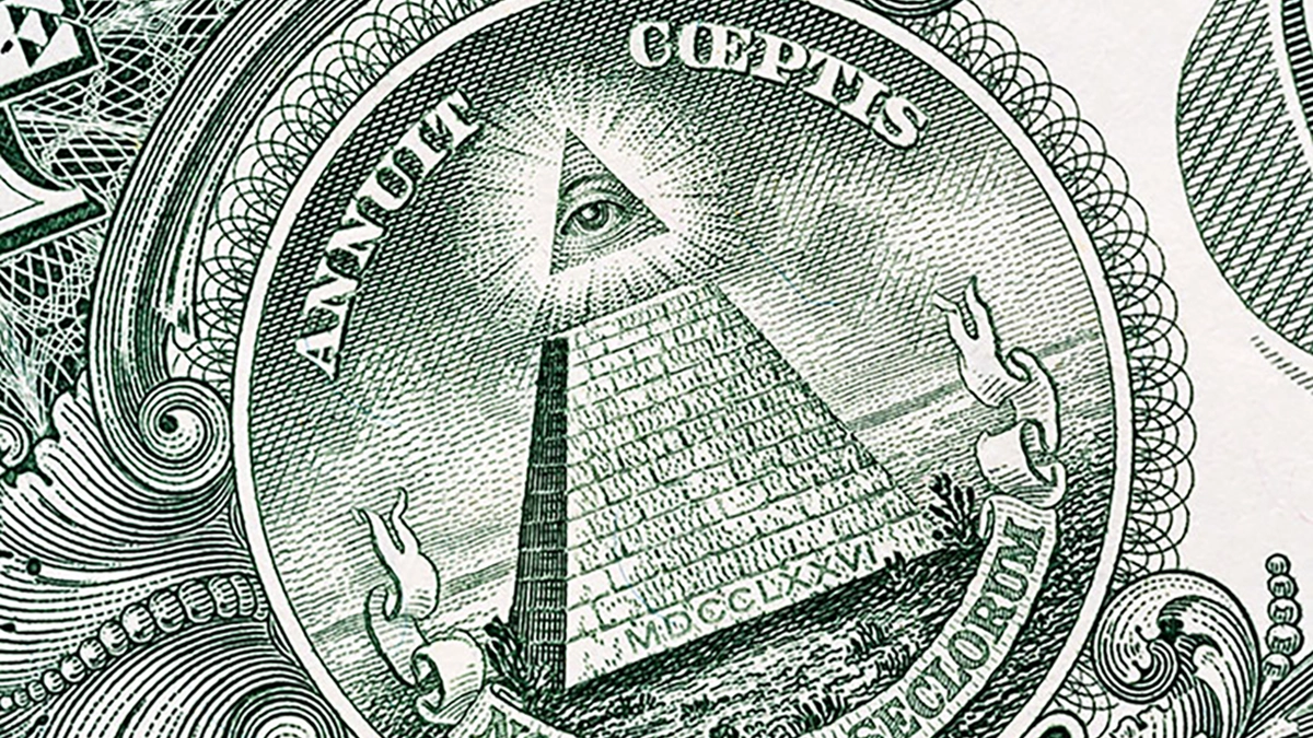 The term "Annuit Coeptis" from the Great Seal of the United States of America as it appears on the back of the $1 Federal Reserve Note. Image: Adobe Stock.