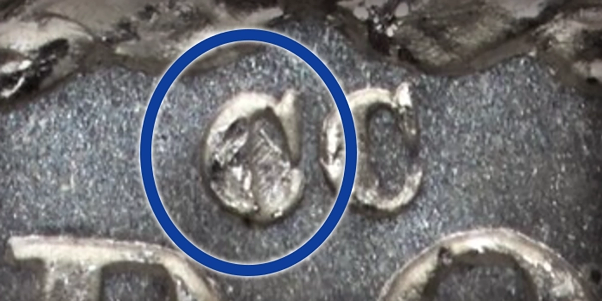 A die scratch within the first C of CC and a doubled date on the obverse are two markers of the 1883-CC Morgan Dollar, VAM-4 variety. Image: Heritage Auctions / CoinWeek.