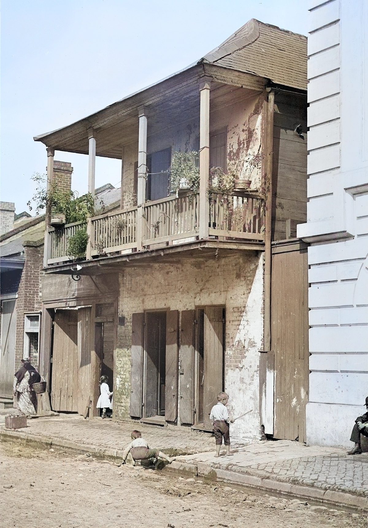 Figure 1. Children playing in the Lower French Quarter in front of a working class house at 67 St. Philip Street (between Royal and Bourbon St.) New Orleans, November 1890. Photo by William Henry Jackson. Courtesy Library of Congress/ colorized by CoinWeek