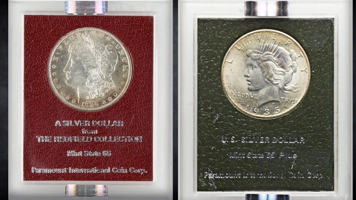 Red and black Paramount holders. The red holder contains an 1896 Morgan dollar from the Redfield Hoard graded MS-65. The coin on the left is a 1935 Peace graded MS-65+. Image: Heritage Auctions.