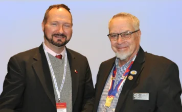 Dennis Tucker receives an award from CSNS. Tucker (left), Mitch Ernst (right).