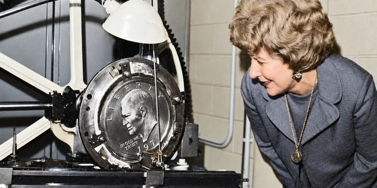 US Mint Director Mary Brooks observes obverse galvano being mechanically reduced to create the master hub for the Eisenhower Dollar.
