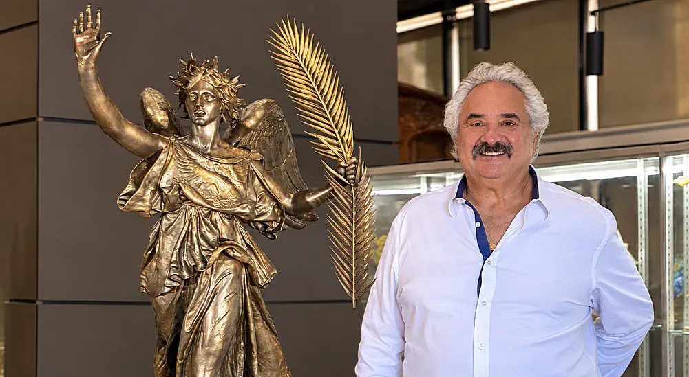 Kevin Lipton, owner of the Lipton Coins, Fine Art & Antiques gallery in Beverly Hills, California, stands next to the $3 million “Victory” statue designed by acclaimed sculptor and coin designer Augustus Saint-Gaudens.