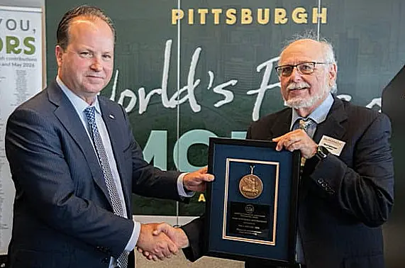 U.S. Mint Director Paul Hollis (left) accepts an ANA Presidential Award from ANA President Mark Lighterman during the show's opening ceremonies.
