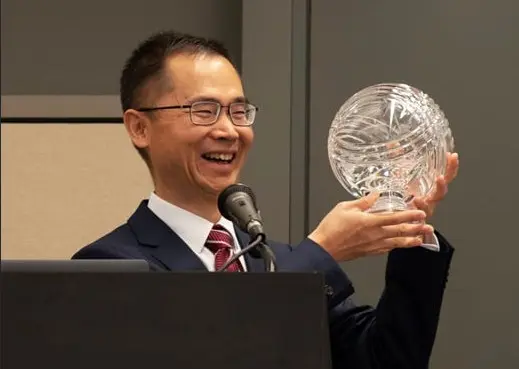Deputy Director of Sales & Marketing Sun Xuan of China Gold Coin Group Co., Ltd. accepted the COTY award for China's Chinese Dragon coin.