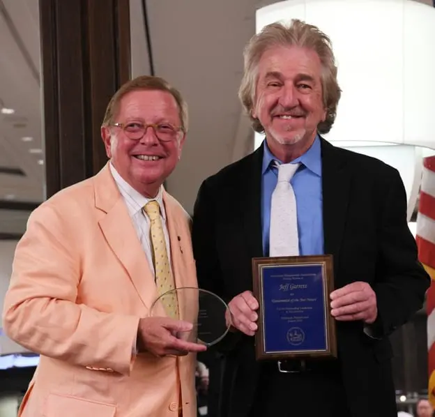 ANA Planned Giving Officer Thomas Uram (left) presents the ANA Numismatist of the Year award to Jeff Garrett during the ANA Banquet.