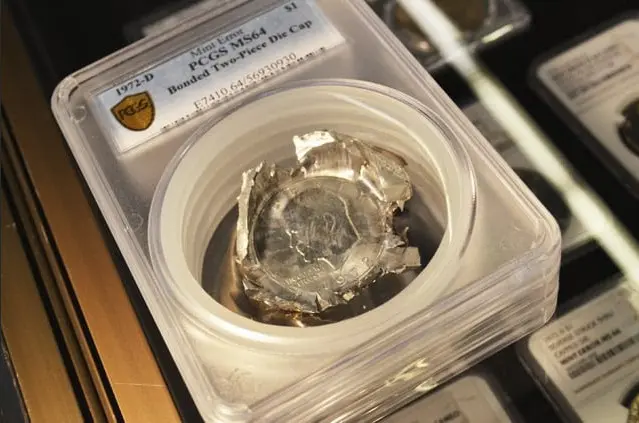 One piece from the error set displayed by GreatCollections, a 1972-D Eisenhower dollar bonded two-piece die cap.