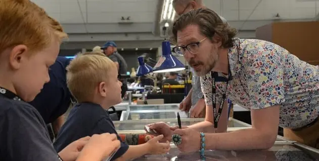 The bourse floor was a bustling hub of activity all week long, including young and experienced collectors alike.