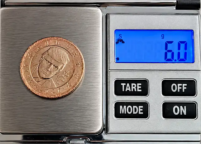 The Dolan Example on a Scale showing weight of 6 Gr.