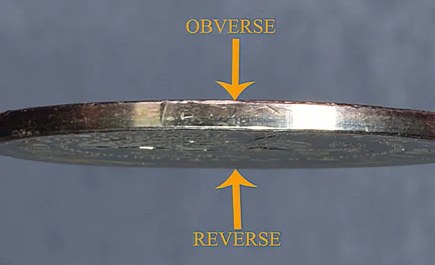 Trump Dollar Error coin edge showing layers