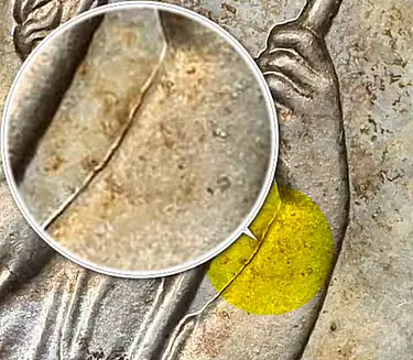 Small Crack Visible from Left Wrist to Drapery